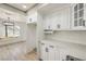 Bright kitchen showcasing white cabinets, quartz counters, stainless appliances, and access to the living room at 2921 Moonlight Bay Ln, Las Vegas, NV 89128