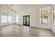 Bright living room featuring modern chandelier lighting and views of the landscaped yard at 2921 Moonlight Bay Ln, Las Vegas, NV 89128