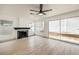 Bright living room features a fireplace, new floors, large windows and sliding door access to the backyard at 2921 Moonlight Bay Ln, Las Vegas, NV 89128