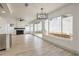 Bright living room showcases fireplace, wood floors, many windows, and partial view of the updated kitchen at 2921 Moonlight Bay Ln, Las Vegas, NV 89128