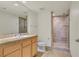 Well-lit bathroom featuring a tiled shower, a modern vanity, and a large mirror at 360 E Desert Inn Rd # 602, Las Vegas, NV 89109