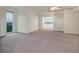 Spacious living room with neutral carpet, and lots of natural light from a large window at 360 E Desert Inn Rd # 602, Las Vegas, NV 89109