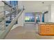 Open living room with industrial staircase, floor-to-ceiling windows, and island kitchen at 360 E Desert Inn Rd # 602, Las Vegas, NV 89109