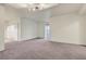 Spacious living room featuring neutral carpet and a sliding glass door for natural light at 360 E Desert Inn Rd # 602, Las Vegas, NV 89109