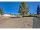 Large, open backyard with a shed, mature tree, and block wall, ready for customization at 3716 N Torrey Pines Dr, Las Vegas, NV 89108