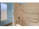 View of a bathtub with a shower inside a bathroom with blue colored walls and a window at 3716 N Torrey Pines Dr, Las Vegas, NV 89108