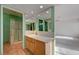 Bathroom featuring a vanity with a sink, framed mirrors and a shower area at 3716 N Torrey Pines Dr, Las Vegas, NV 89108