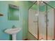 Bathroom featuring a sink, framed mirror and a shower area with turquoise walls at 3716 N Torrey Pines Dr, Las Vegas, NV 89108