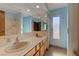 Bathroom with double sinks, mirrors, tiled countertops, and a shower/tub combo with blue walls at 3716 N Torrey Pines Dr, Las Vegas, NV 89108