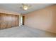 This bedroom features carpeted floors, a ceiling fan, and a closet at 3716 N Torrey Pines Dr, Las Vegas, NV 89108