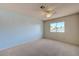 This bedroom features carpeted floors, a ceiling fan, and a view from the window at 3716 N Torrey Pines Dr, Las Vegas, NV 89108