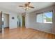 Bright bedroom with hardwood floors, a ceiling fan, and a window offering views of the outdoors at 3716 N Torrey Pines Dr, Las Vegas, NV 89108