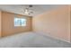 This bedroom features carpeted floors, a ceiling fan, and a view from the window at 3716 N Torrey Pines Dr, Las Vegas, NV 89108