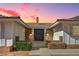 Charming front exterior showcasing a brick facade, double door entry, and manicured landscaping at 3716 N Torrey Pines Dr, Las Vegas, NV 89108