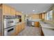 Spacious kitchen with stainless steel appliances, wooden cabinets, and ample counter space for culinary enthusiasts at 3716 N Torrey Pines Dr, Las Vegas, NV 89108