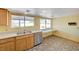 Bright kitchen featuring wood cabinets, stainless steel appliances, and a large window overlooking the yard at 3716 N Torrey Pines Dr, Las Vegas, NV 89108