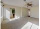 Bright living room with carpet, ceiling fan, and doorway leading to another room, filled with natural light at 3716 N Torrey Pines Dr, Las Vegas, NV 89108