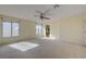 This living room features carpeted floors and several windows allowing natural light at 3716 N Torrey Pines Dr, Las Vegas, NV 89108