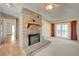 Cozy living room with a brick fireplace, ceiling fan, and direct access to the backyard at 3716 N Torrey Pines Dr, Las Vegas, NV 89108