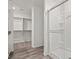 Bathroom featuring a glass door shower, wood floors, and a built-in closet at 4203 Gold Desert St, North Las Vegas, NV 89032