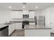 Modern kitchen featuring stainless steel appliances, white cabinetry, and a center island at 4203 Gold Desert St, North Las Vegas, NV 89032