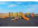 Community playground features multiple slides and play structures for children in a safe and fun environment at 4203 Gold Desert St, North Las Vegas, NV 89032