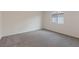 Neutral carpeted bedroom with large window allowing for natural light at 4215 Gold Desert St, North Las Vegas, NV 89032