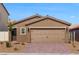 Inviting single-story home featuring a well-manicured front yard and a two-car garage at 4215 Gold Desert St, North Las Vegas, NV 89032