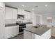 Stylish kitchen featuring white cabinetry, stainless steel appliances, and a central island at 4223 Gold Desert St, North Las Vegas, NV 89032