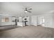 Bright open-concept living area with a ceiling fan, flowing into the kitchen with modern appliances at 4223 Gold Desert St, North Las Vegas, NV 89032