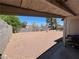 This image shows a covered patio overlooking a spacious backyard with gravel and block wall fencing at 4312 Alpine Pl, Las Vegas, NV 89107