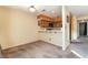 Bright dining room showcases the view to the kitchen with warm tone walls and carpet flooring at 4425 Woodpine Dr # 104, Las Vegas, NV 89119