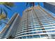 Modern high-rise condominium featuring floor-to-ceiling windows and private balconies against a clear blue sky at 4575 Dean Martin Dr # 505, Las Vegas, NV 89103