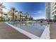 Modern outdoor community pool with palm trees and surrounding buildings at 4575 Dean Martin Dr # 505, Las Vegas, NV 89103