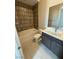 This bathroom has a tub, toilet, and large vanity with modern finishes at 4630 Blushing Dawn Ave, Las Vegas, NV 89118