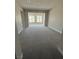 Spacious carpeted room with bright natural light from two windows, ideal for a bedroom or living area at 4630 Blushing Dawn Ave, Las Vegas, NV 89118