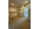 Large carpeted walk-in closet featuring built in shelving to maximize storage at 4630 Blushing Dawn Ave, Las Vegas, NV 89118