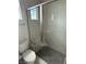 Modern bathroom featuring a walk-in glass shower with built-in seat and gray tiling at 4630 Blushing Dawn Ave, Las Vegas, NV 89118