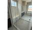 Beautiful tiled shower with a glass door, built-in seat, and stylish fixtures in a modern bathroom at 4630 Blushing Dawn Ave, Las Vegas, NV 89118