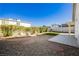 Large backyard featuring decorative rock, stepping stones, and a small patch of artificial turf at 4666 Amberwood Ln, Las Vegas, NV 89147