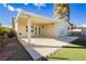 View of the backyard with a covered patio, artificial grass, and a storage shed at 4666 Amberwood Ln, Las Vegas, NV 89147