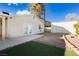 Private backyard featuring a patio, artificial turf, gravel landscaping, and a storage shed at 4666 Amberwood Ln, Las Vegas, NV 89147