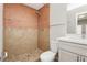 Tiled bathroom featuring a shower with neutral toned tile, with vanity and mirror at 4666 Amberwood Ln, Las Vegas, NV 89147