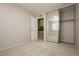 Bright bedroom featuring neutral carpet and mirrored closet with shelving for ample storage at 4666 Amberwood Ln, Las Vegas, NV 89147