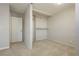 Bright bedroom featuring neutral carpet and a closet with shelving for ample storage at 4666 Amberwood Ln, Las Vegas, NV 89147