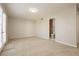 Bright bedroom with neutral carpet, light walls, and a bathroom provides a serene space at 4666 Amberwood Ln, Las Vegas, NV 89147