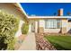 Close up of the home's front entrance and picture window, surrounded by rock landscaping at 4666 Amberwood Ln, Las Vegas, NV 89147