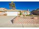 Charming single-story home with a two-car garage, xeriscaped front yard, and mature shade tree at 4666 Amberwood Ln, Las Vegas, NV 89147