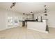 Open concept kitchen with stainless steel appliances, breakfast bar, and tile floors at 4666 Amberwood Ln, Las Vegas, NV 89147