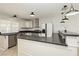 Bright kitchen with stainless steel appliances, white cabinetry, and granite countertops provides a modern feel at 4666 Amberwood Ln, Las Vegas, NV 89147